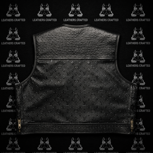 Black leather motorcycle vest with an embossed monogram pattern, shown from the back against a black background with repeating 'Leathers Crafted' logos.