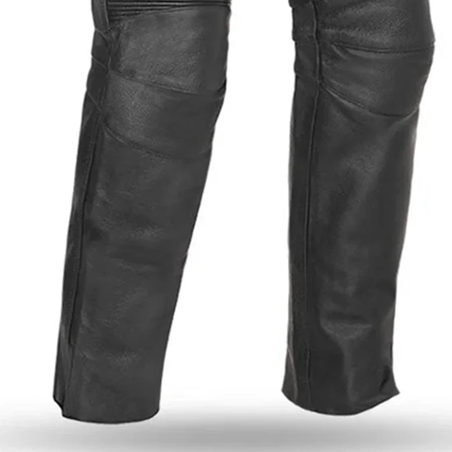 Black leather chaps or leg guards with diagonal paneling and side pockets, shown on a white background.