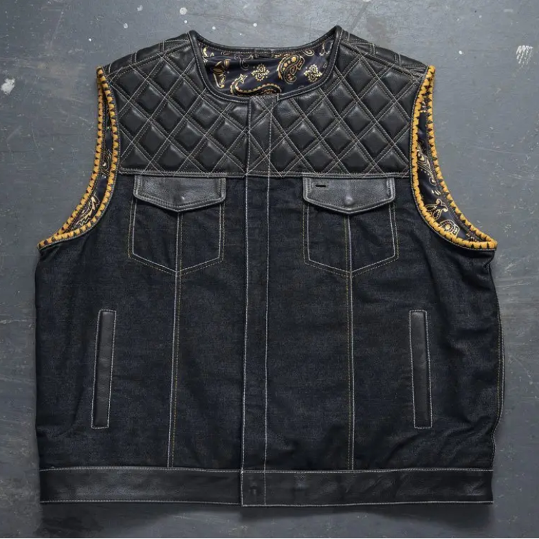 Men's black denim motorcycle vest with quilted leather yoke and gold whipstitch trim