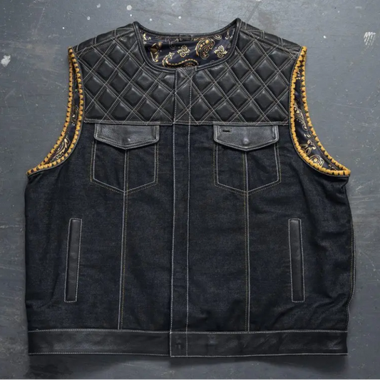 Men's black denim motorcycle vest with quilted leather yoke and gold whipstitch trim