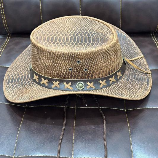 Woven hat with decorative band on a dark leather surface