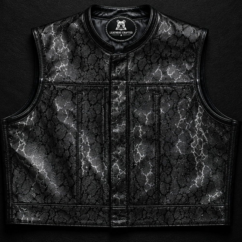 A black leather motorcycle vest with a textured, cracked pattern and a central zipper, displayed flat against a dark textured background with a 'LEATHERS CRAFTED' logo at the top.